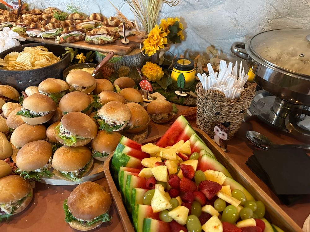A spread of assorted buffet items including sliders, chips, fruit pieces, and other appetizers for funeral catering in central Massachusetts.